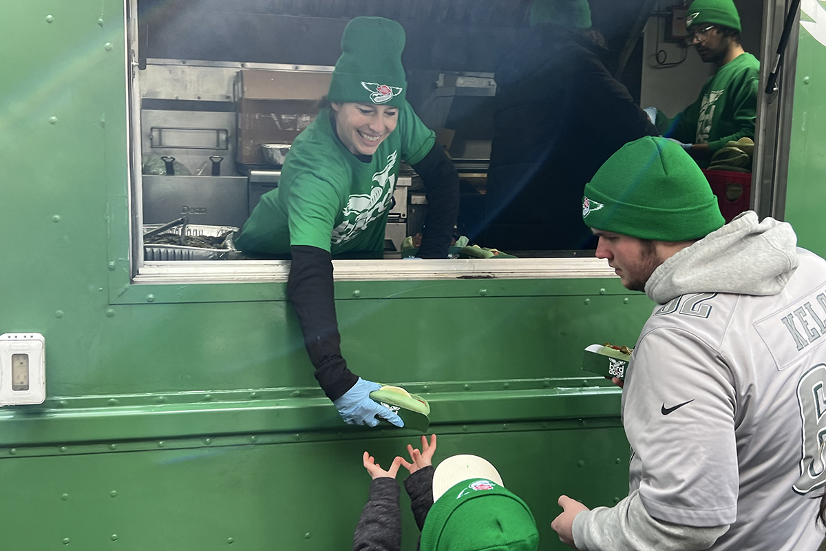 Polaris brand ambassadors serving Dietz & Watson Bird Dogs to Eagles fans at a Philadelphia food truck promotion